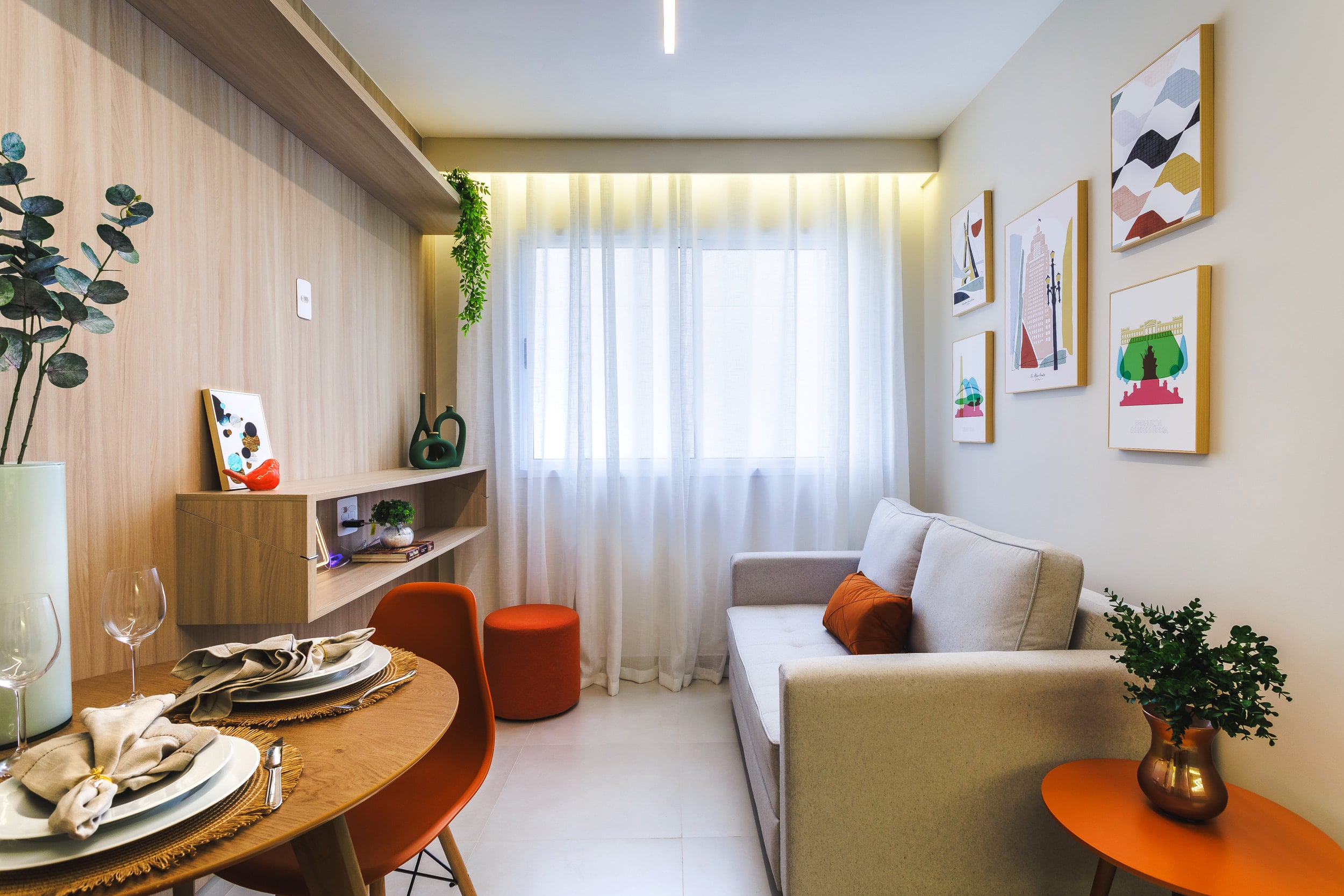 Sala de estar com sofá cinza, pufes terracota e prateleira decorativa